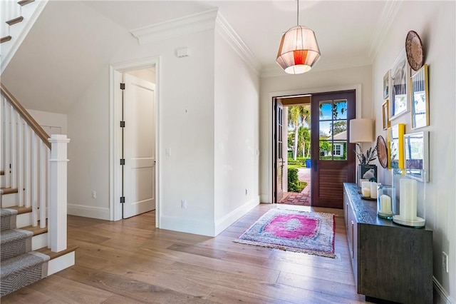 foyer featuring crown molding and light hardwood / wood-style floors