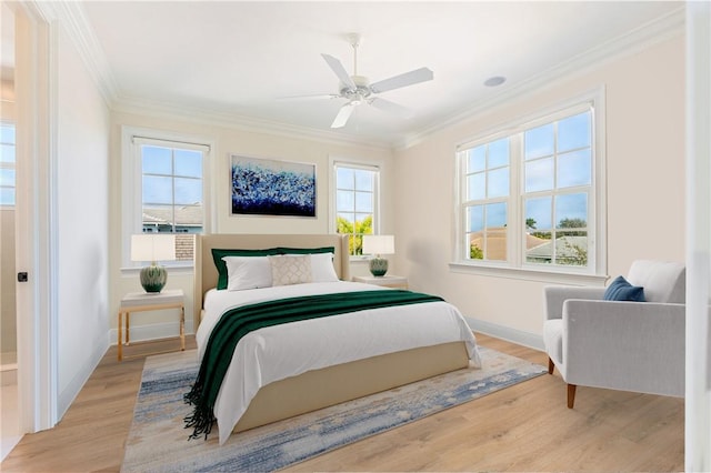 bedroom featuring light hardwood / wood-style flooring, ornamental molding, and ceiling fan