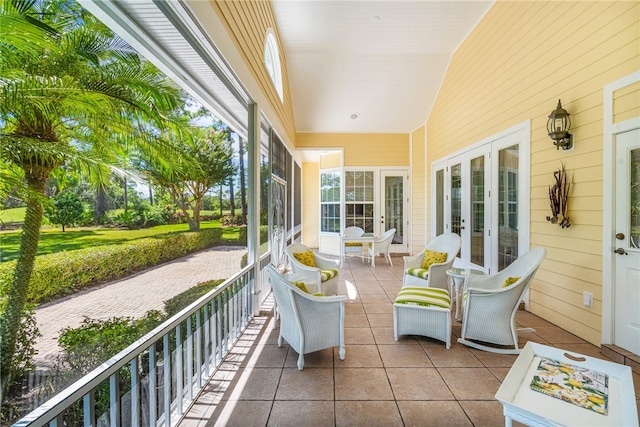 sunroom / solarium featuring french doors and lofted ceiling