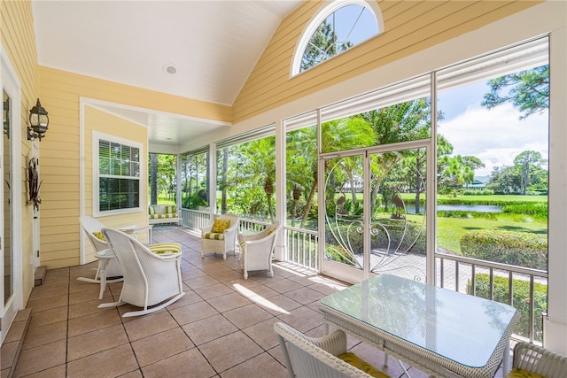 sunroom with a water view and vaulted ceiling