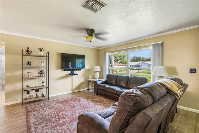5845 23rd St, Vero Beach, FL 32966 - living area with crown molding, wood finished floors, baseboards, a ceiling fan, and a textured ceiling