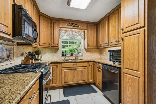 5845 23rd St, Vero Beach, FL 32966 - kitchen with stainless steel gas range oven, dishwashing machine, black microwave, and brown cabinetry