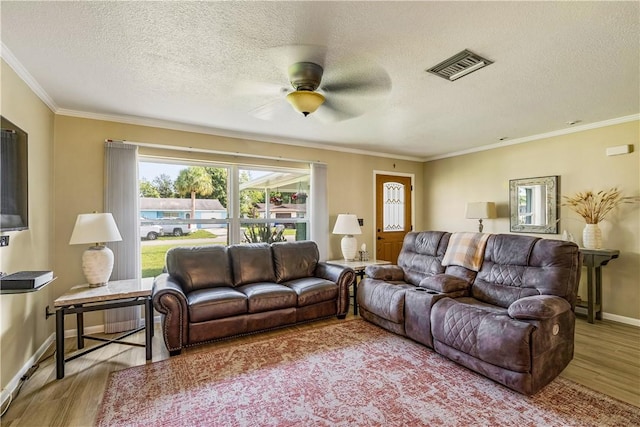 5845 23rd St, Vero Beach, FL 32966 - living area featuring wood finished floors, a ceiling fan, a textured ceiling, baseboards, and crown molding