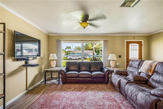 5845 23rd St, Vero Beach, FL 32966 - living room with ceiling fan, wood finished floors, baseboards, crown molding, and a textured ceiling