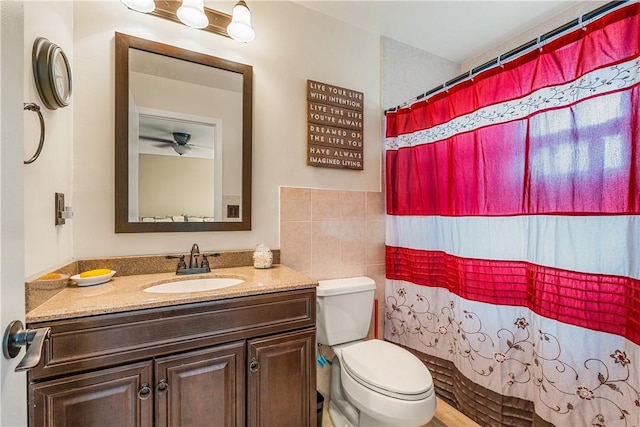 5845 23rd St, Vero Beach, FL 32966 - full bathroom with toilet, vanity, a shower with shower curtain, and tile walls