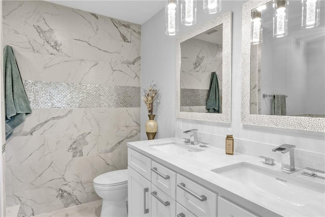 bathroom with vanity, tile walls, and toilet