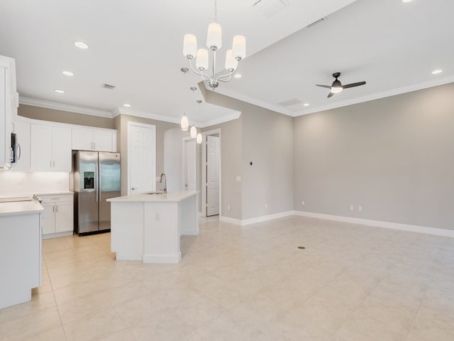 kitchen featuring appliances with stainless steel finishes, decorative light fixtures, a center island with sink, and white cabinets