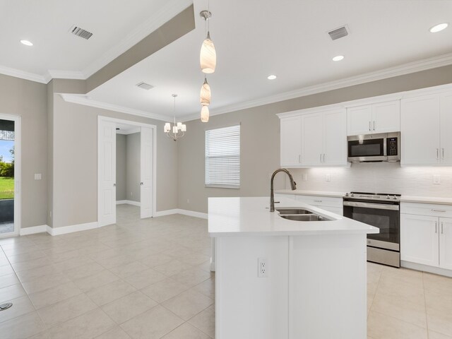 kitchen featuring a kitchen island with sink, stainless steel appliances, a healthy amount of sunlight, and sink