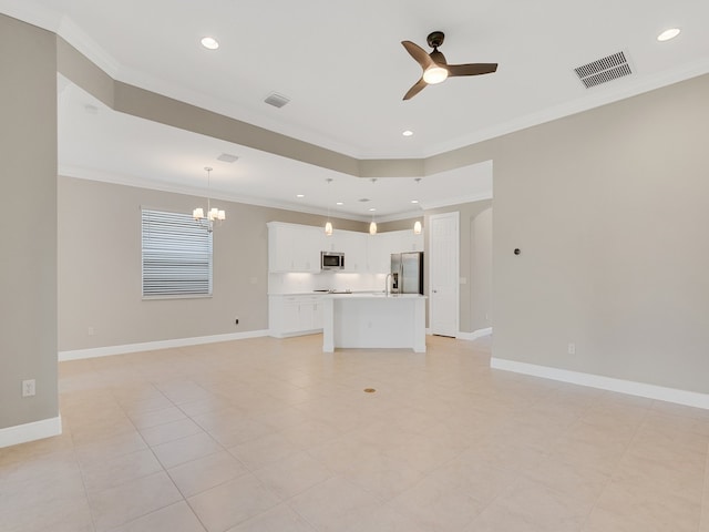 unfurnished living room with ceiling fan with notable chandelier, light tile patterned floors, crown molding, and sink