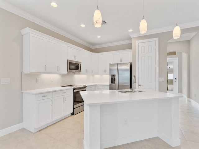 kitchen featuring stainless steel appliances, white cabinets, sink, and decorative light fixtures