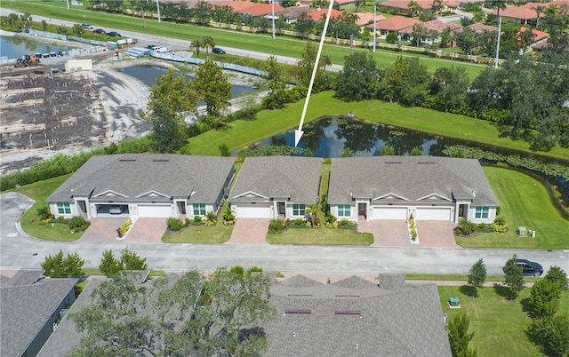 birds eye view of property with a water view