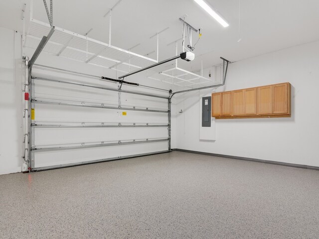 garage featuring electric panel and a garage door opener