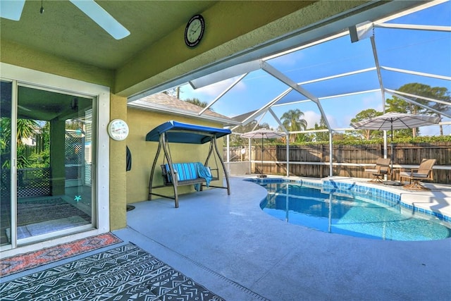 view of pool featuring a patio area and glass enclosure