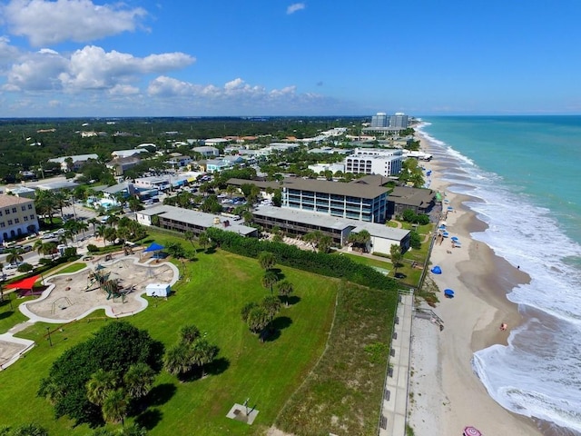 birds eye view of property with a water view and a view of the beach