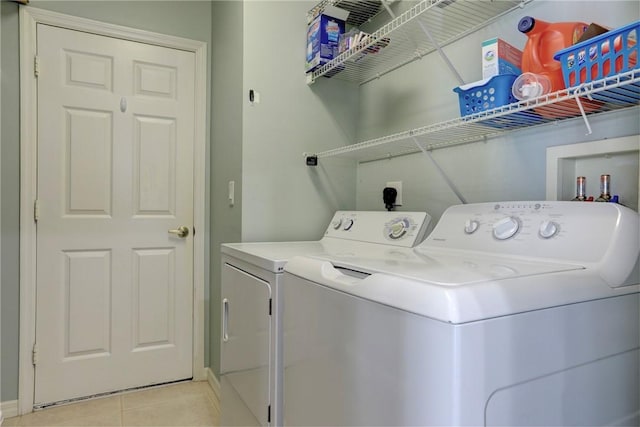 laundry room featuring light tile patterned floors and washer and dryer