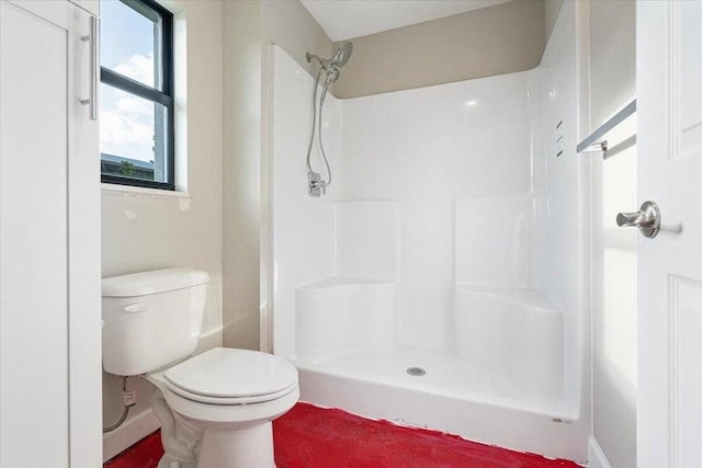 bathroom with a shower and toilet