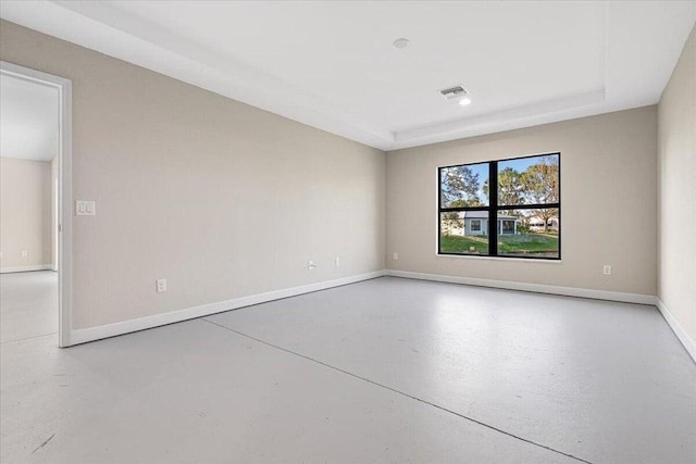 unfurnished room with concrete flooring