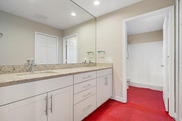 bathroom featuring a shower, vanity, and toilet