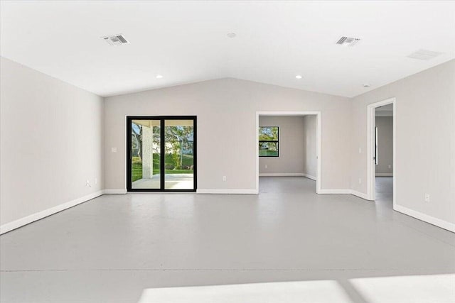 empty room with concrete floors and lofted ceiling