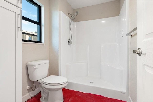 bathroom with a shower and toilet