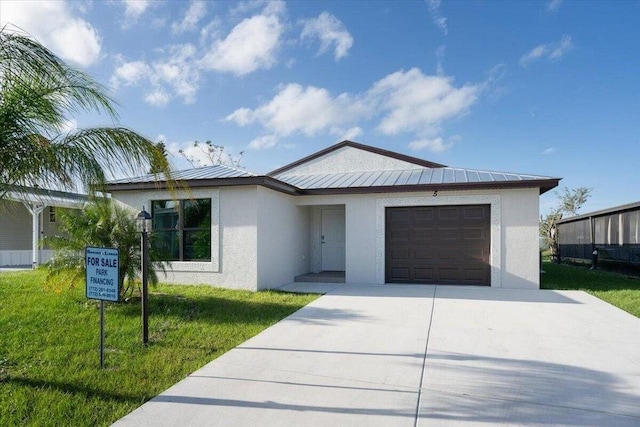 view of front of house with a garage and a front lawn