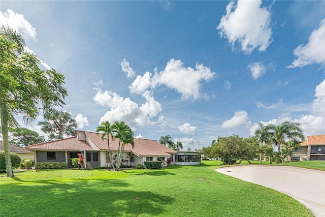 single story home featuring a front lawn