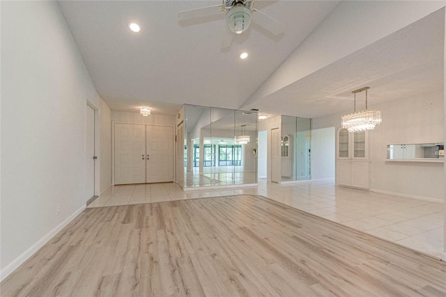 unfurnished room featuring light wood-type flooring, lofted ceiling, and ceiling fan