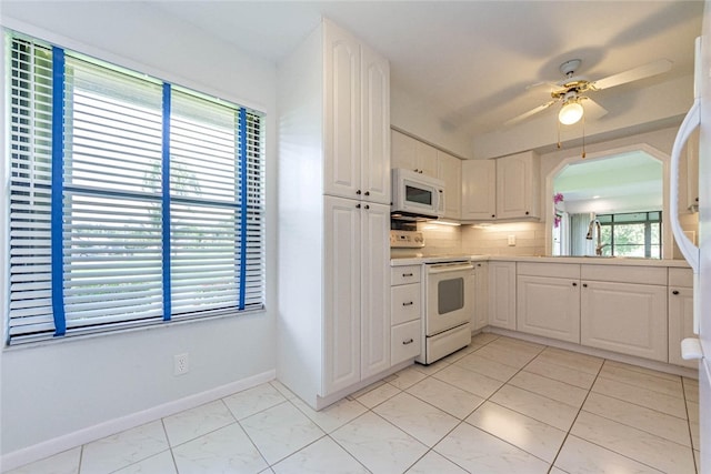 kitchen featuring white cabinetry, sink, ceiling fan, white appliances, and decorative backsplash