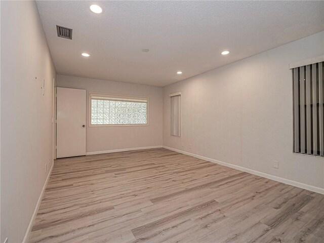 spare room with light wood-type flooring