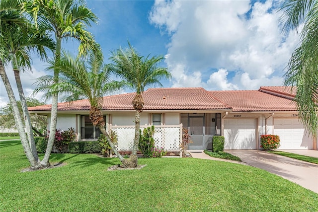 view of front of house with a garage and a front lawn