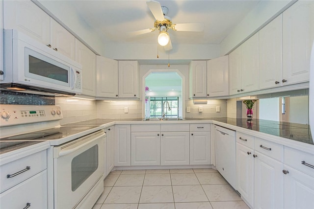 kitchen featuring white cabinetry, a healthy amount of sunlight, and white appliances