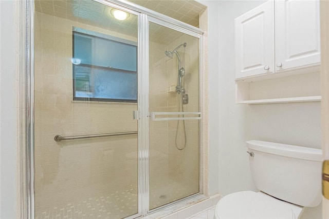 bathroom with toilet and an enclosed shower