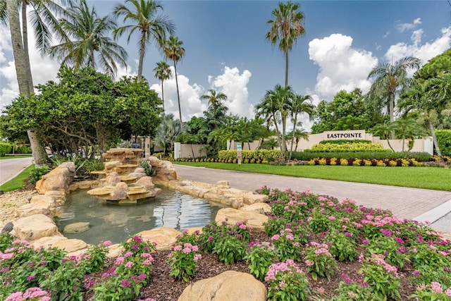 view of community featuring a garden pond