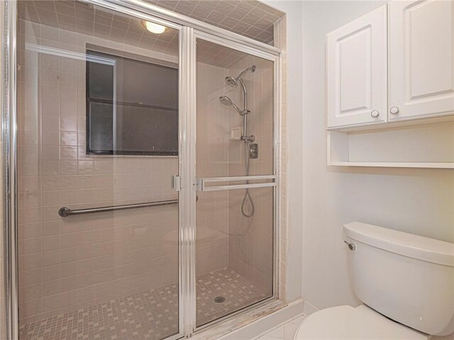 bathroom featuring walk in shower, vanity, and tile patterned floors