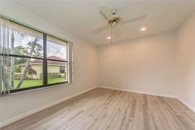 spare room with light hardwood / wood-style floors and ceiling fan