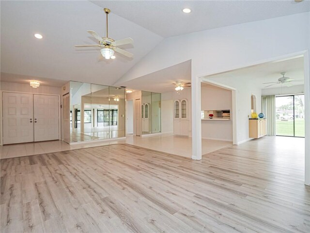 empty room with light hardwood / wood-style flooring, ceiling fan, and plenty of natural light