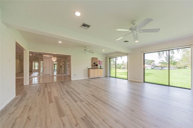 unfurnished living room with light hardwood / wood-style flooring and ceiling fan