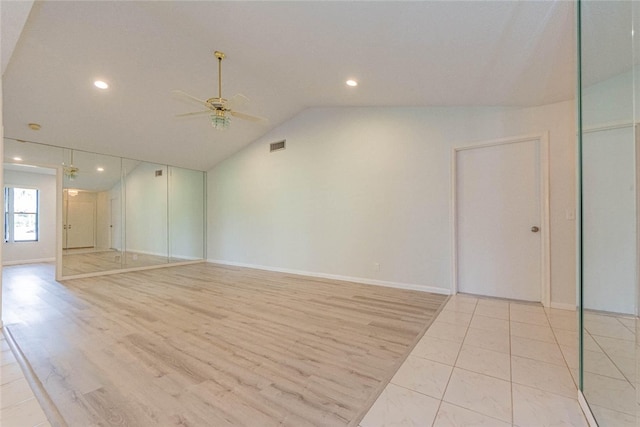 unfurnished room with lofted ceiling, ceiling fan, and light hardwood / wood-style flooring