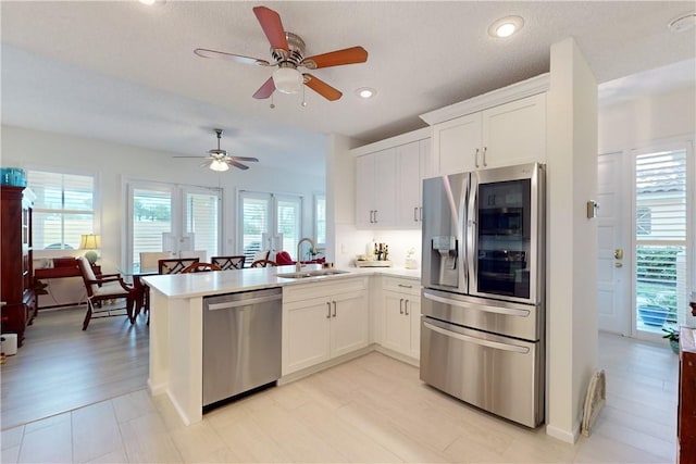 4853 N Newport Island Dr Unit 12B, Vero Beach, FL 32967 - kitchen with appliances with stainless steel finishes, a peninsula, a ceiling fan, plenty of natural light, and recessed lighting