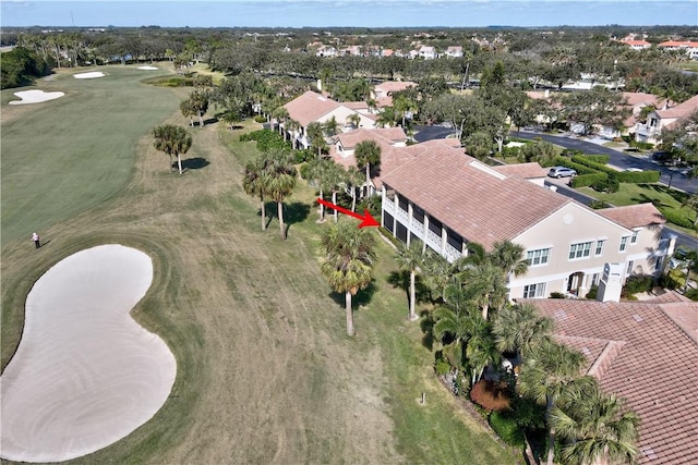 drone / aerial view with view of golf course and a residential view