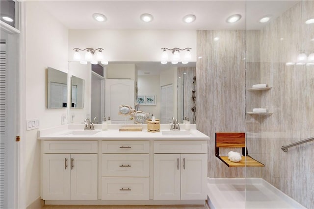 bathroom with walk in shower and vanity