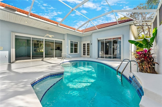 view of pool with a patio, ceiling fan, and a lanai