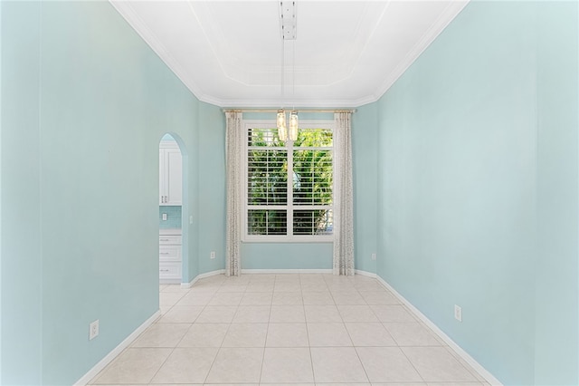 unfurnished room with ornamental molding, light tile patterned floors, a chandelier, and a raised ceiling