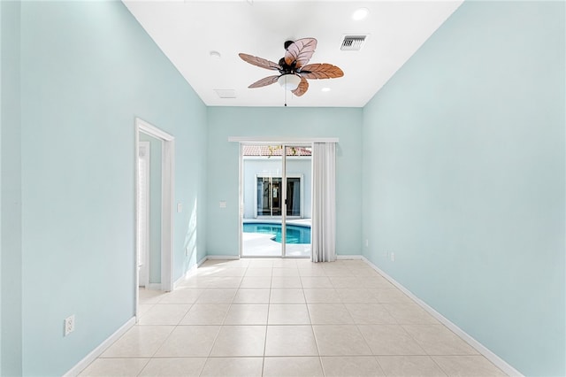 tiled empty room featuring ceiling fan