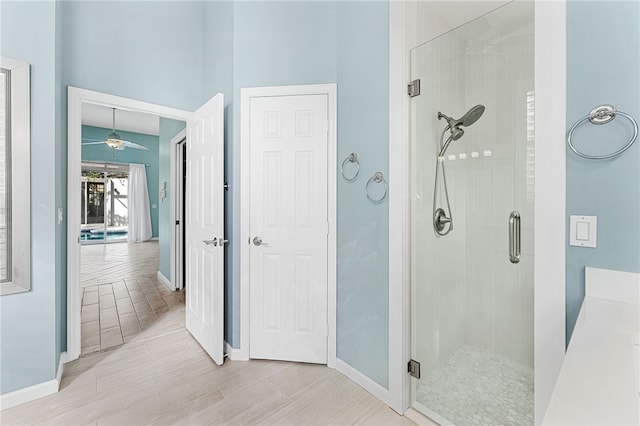 bathroom featuring a towering ceiling and a shower with shower door