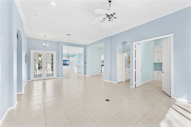 empty room featuring french doors, ceiling fan with notable chandelier, crown molding, and light tile patterned floors