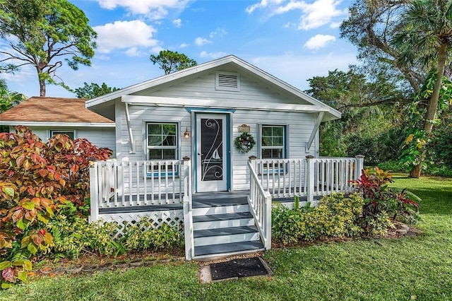 bungalow-style home featuring a front yard and a porch