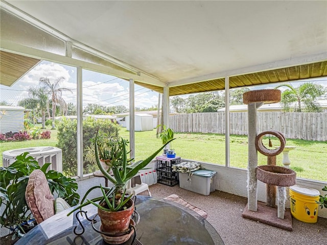 sunroom / solarium featuring vaulted ceiling