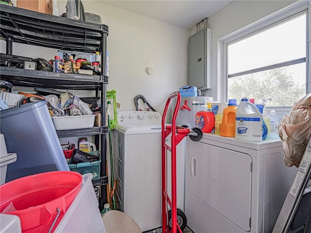 laundry area featuring electric panel and separate washer and dryer