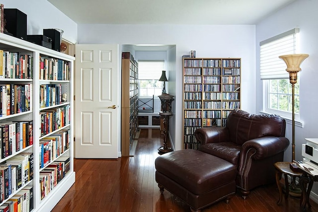 sitting room with dark wood-type flooring